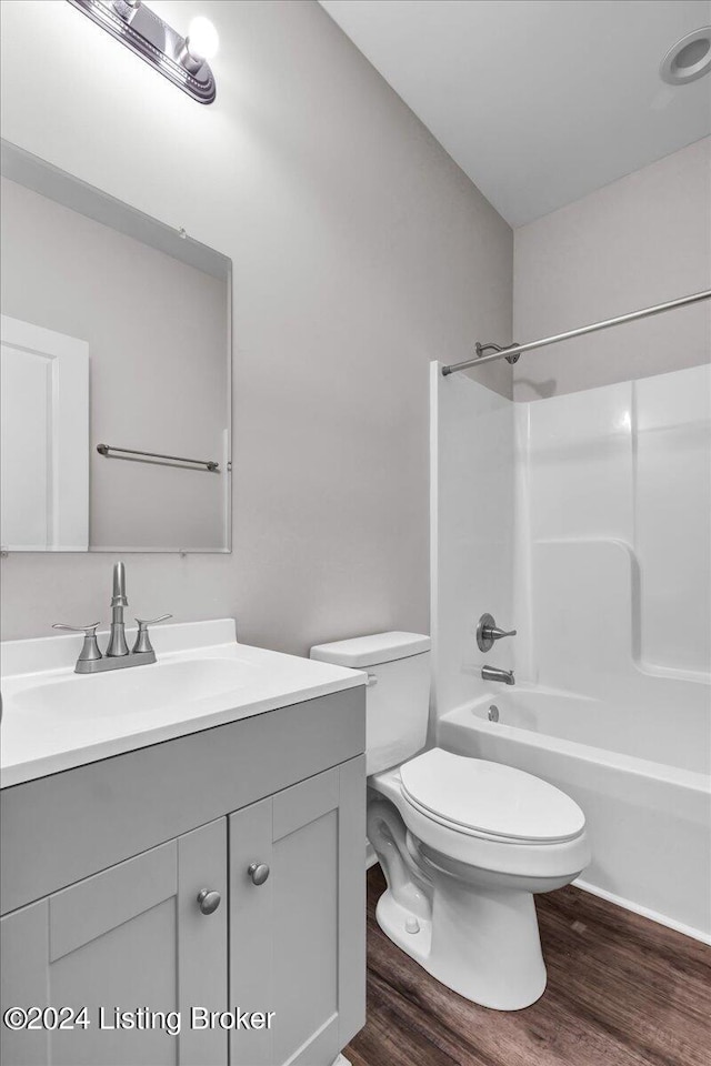 full bathroom with vanity, toilet, shower / bathtub combination, and wood-type flooring