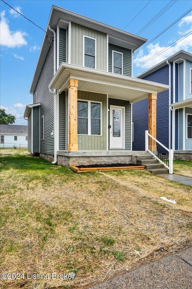 view of front of property featuring a front lawn and covered porch