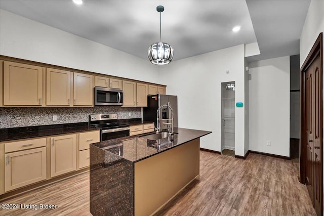 kitchen featuring appliances with stainless steel finishes, tasteful backsplash, and hardwood / wood-style floors