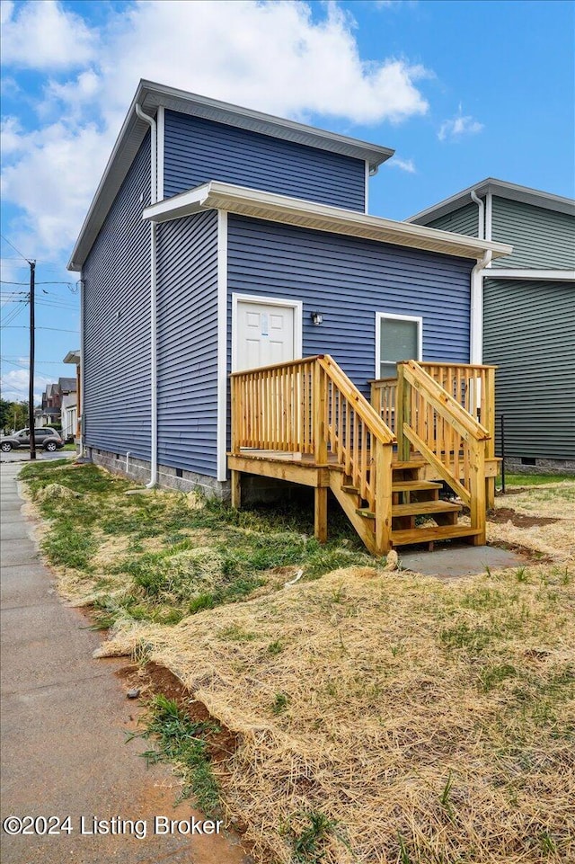 back of house featuring a deck