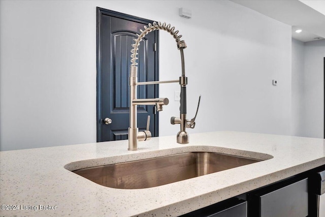 room details with light stone counters and sink