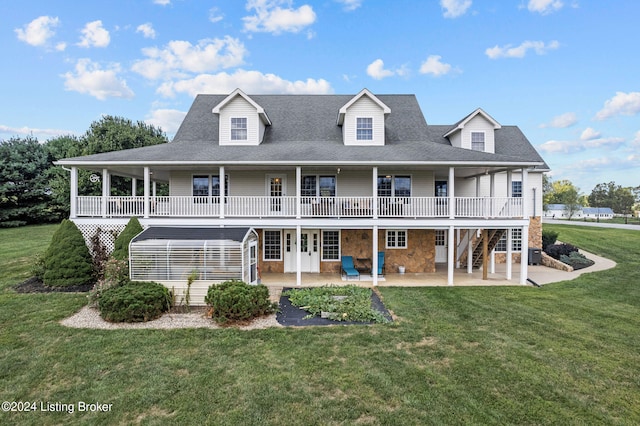 back of house featuring a patio area, a lawn, and french doors