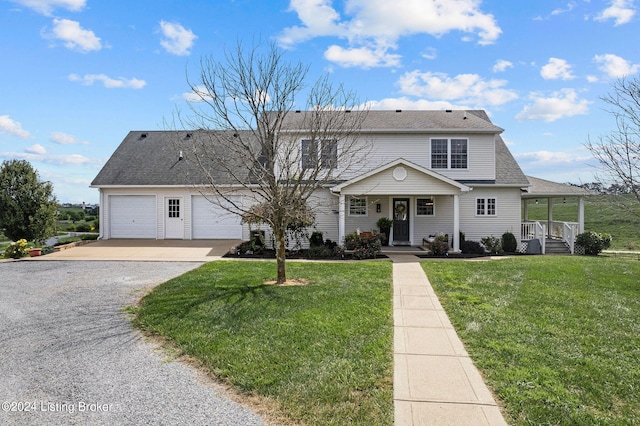 view of front property with a garage, a porch, and a front yard