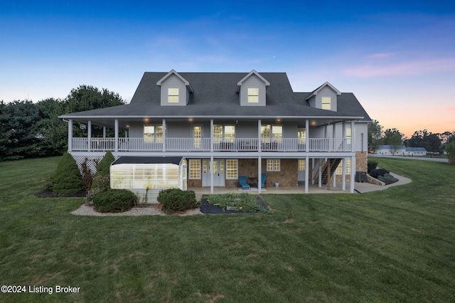 view of front of home with a lawn and a patio