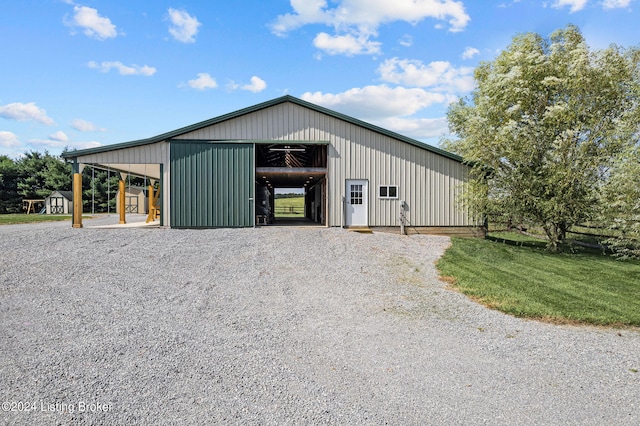 view of outdoor structure with a garage and a carport