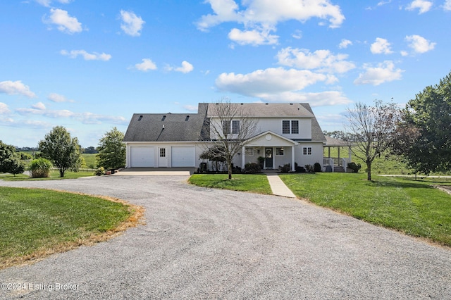 front of property with a garage and a front yard