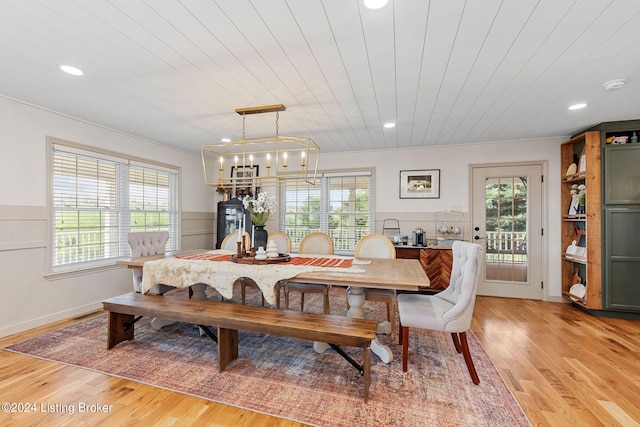 dining area with light hardwood / wood-style flooring and a healthy amount of sunlight