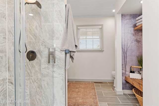 bathroom with toilet, a shower with shower door, and tile patterned flooring