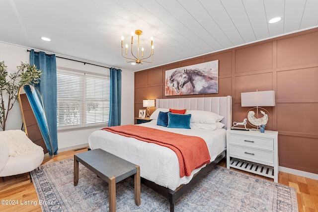 bedroom with wood-type flooring and a chandelier