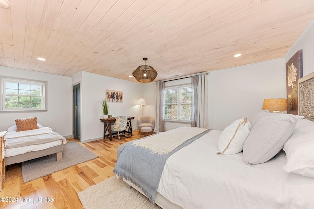 bedroom featuring multiple windows, wood ceiling, and light hardwood / wood-style floors