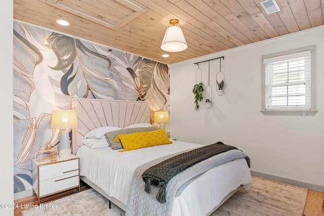 bedroom with light wood-type flooring and wooden ceiling