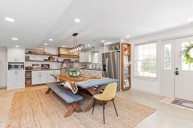 tiled dining room featuring sink