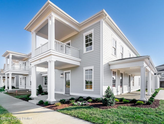 view of front facade featuring a balcony and covered porch