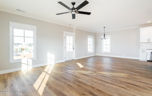 unfurnished living room featuring crown molding, ceiling fan with notable chandelier, and light hardwood / wood-style floors