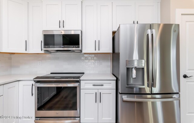 kitchen featuring decorative backsplash, appliances with stainless steel finishes, white cabinetry, and light countertops