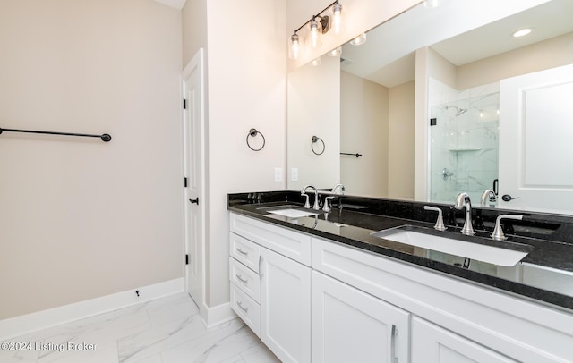 full bathroom featuring a marble finish shower, marble finish floor, baseboards, and a sink