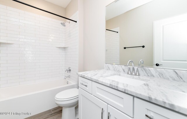 bathroom with bathing tub / shower combination, toilet, wood finished floors, and vanity