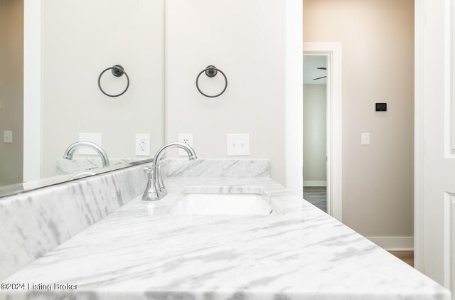 bathroom with vanity and baseboards