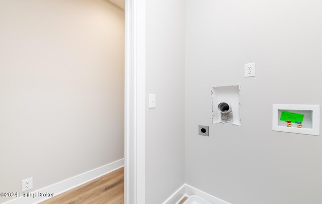 clothes washing area featuring baseboards, laundry area, hookup for a washing machine, light wood-style floors, and electric dryer hookup