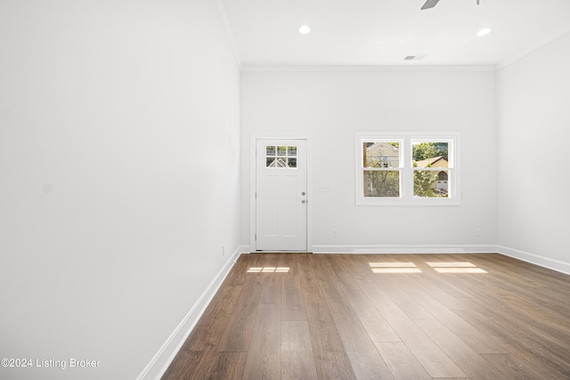 unfurnished room featuring ceiling fan, ornamental molding, and hardwood / wood-style flooring