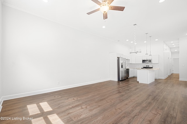 unfurnished living room with crown molding, hardwood / wood-style flooring, and ceiling fan