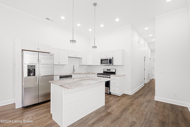 kitchen with white cabinetry, a kitchen island, appliances with stainless steel finishes, and dark hardwood / wood-style flooring