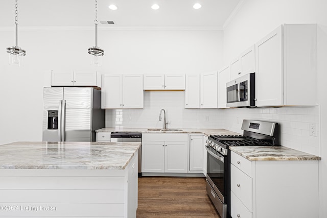 kitchen featuring decorative light fixtures, stainless steel appliances, sink, dark wood-type flooring, and ornamental molding