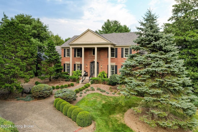 neoclassical / greek revival house featuring brick siding