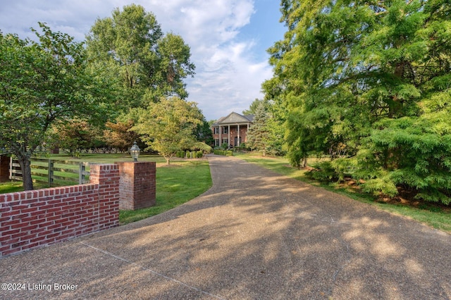 view of front facade with a front yard and fence