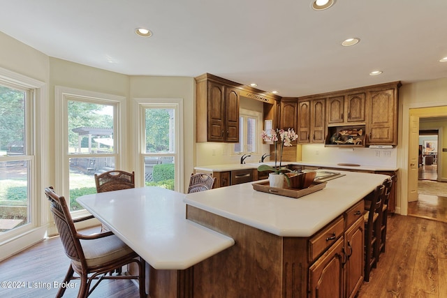 kitchen with a center island, dark wood-style floors, light countertops, and recessed lighting
