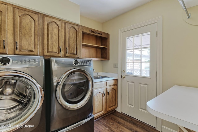 clothes washing area with dark wood finished floors, separate washer and dryer, cabinet space, and a sink