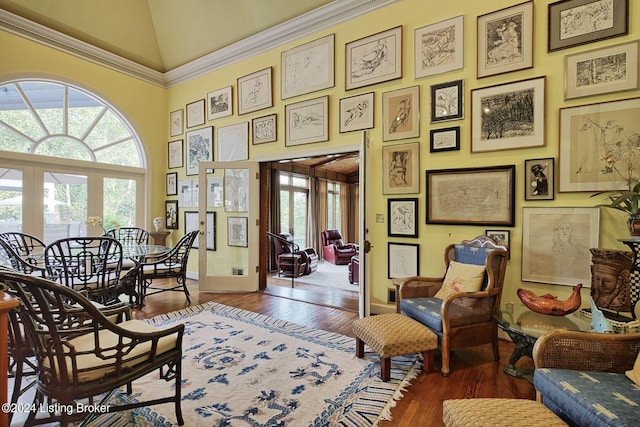 sitting room with high vaulted ceiling, french doors, baseboards, and wood finished floors