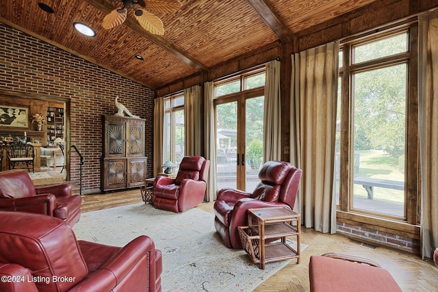 living room with visible vents, plenty of natural light, lofted ceiling, brick wall, and wood ceiling