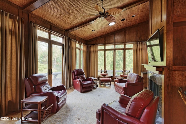 living area with wood ceiling, french doors, lofted ceiling, a high end fireplace, and ceiling fan