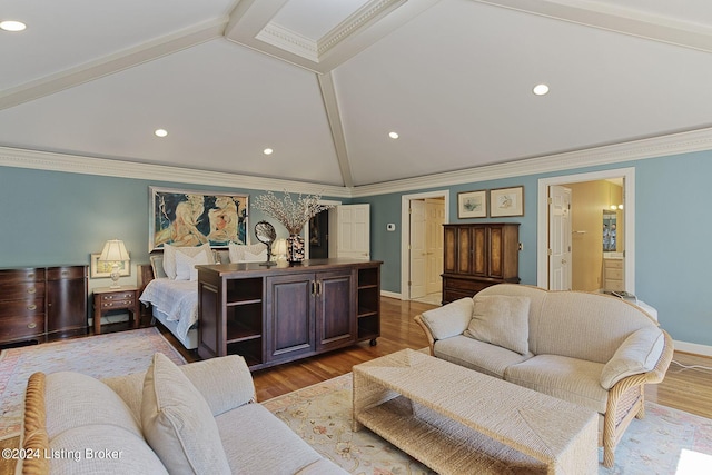 bedroom featuring ornamental molding, vaulted ceiling with beams, baseboards, and wood finished floors