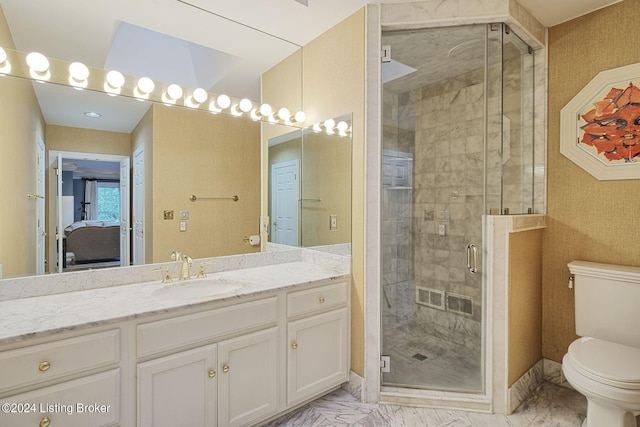 full bathroom featuring marble finish floor, toilet, a shower stall, vanity, and baseboards