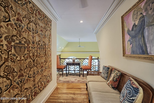 hallway with ornamental molding, lofted ceiling, baseboards, and wood finished floors