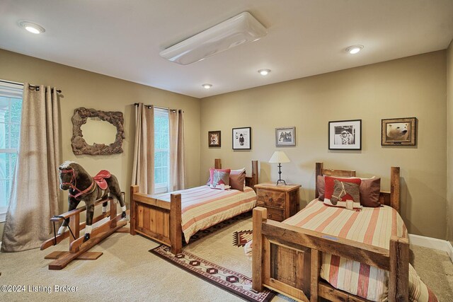 bedroom with multiple windows, light colored carpet, and recessed lighting