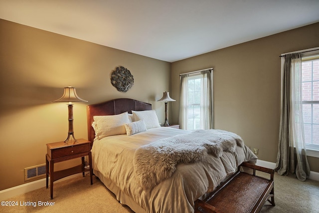 carpeted bedroom featuring visible vents and baseboards