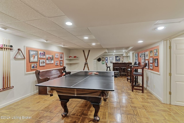 playroom with a bar, recessed lighting, a drop ceiling, and baseboards