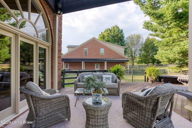 view of patio with outdoor lounge area and a deck