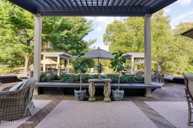 view of patio / terrace featuring a wooden deck and a pergola