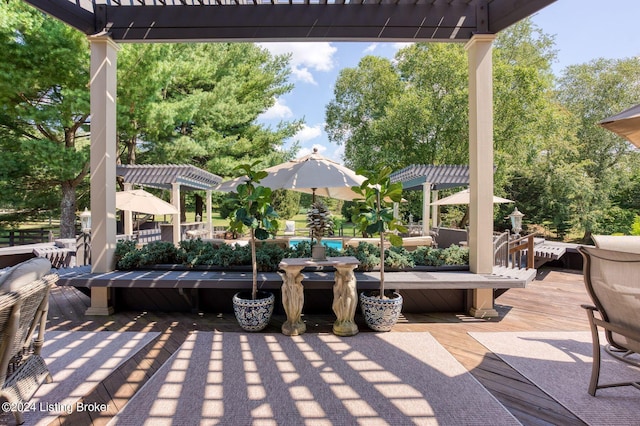 view of patio featuring a pergola and a deck