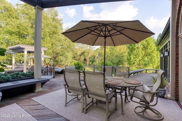 view of patio / terrace featuring a wooden deck and outdoor dining space