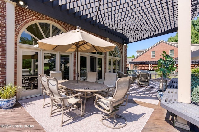 view of patio featuring outdoor dining space, a deck, and a pergola