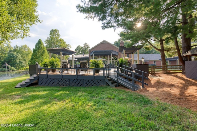 view of playground featuring a yard, stairs, fence, a wooden deck, and a pergola