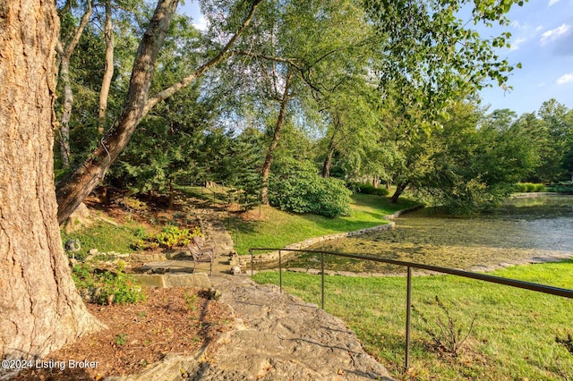 view of yard featuring a water view and fence