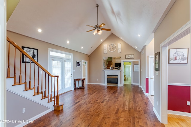 foyer with high vaulted ceiling, wood-type flooring, and ceiling fan