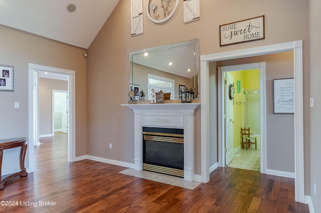 living room with high vaulted ceiling and hardwood / wood-style flooring