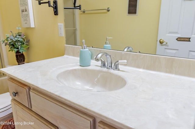 bathroom featuring toilet and vanity